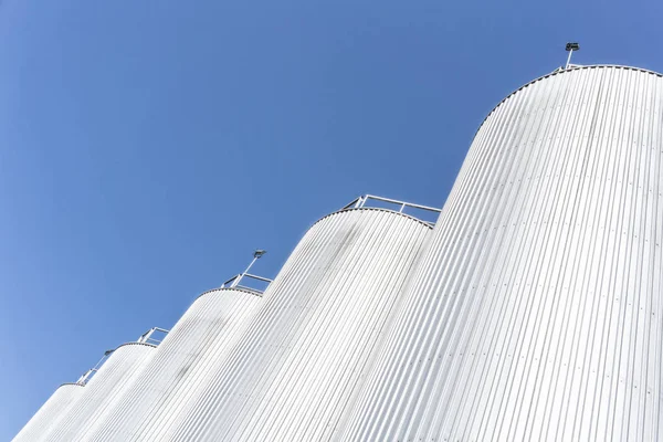 İçecek fabrika silindir. Mavi gökyüzü ile.