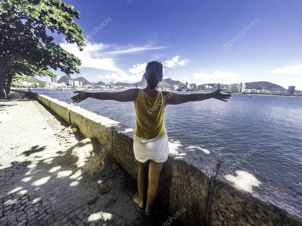 Young girl with open arms to sugar loaf Brazil, Rio de Janeiro