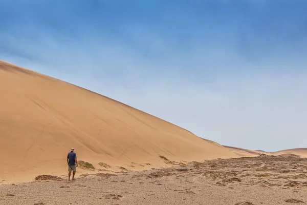 Man walking in the Namibe Desert. Africa. Angola.