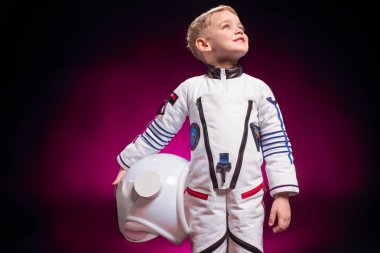 adorable boy in astronaut costume on colorful background clipart