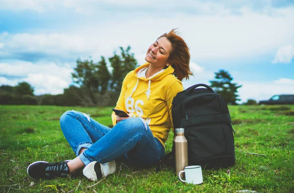 woman relax holding in female hands gadget technology, tourist young girl on background green grass using mobile smartphone, hiker enjoy recreation online wifi internet lifestyle concept