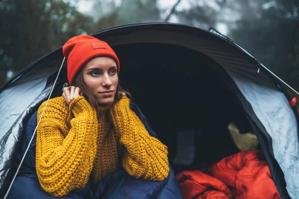 tourist traveler ralaxing in camp tent in froggy rain forest, closeup lonely hiker woman enjoy mist nature trip, green trekking tourism, rest vacation concept camping holiday