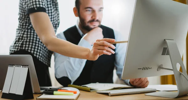 Workplace teamwork concept, colleague discuss startup project. Bearded young businessman working at office. Director man thinking looking in monitor computer. Managers meeting. Idea, alalyze marketing plans