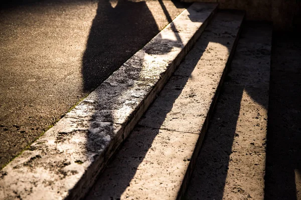 Stone stairs with dark shadows at sunset