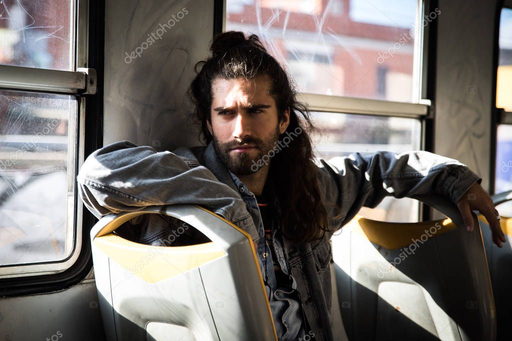 Hipster man posing in public transport 