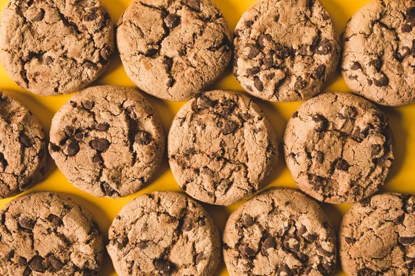 close up of a chocolate cookies on a yellow background