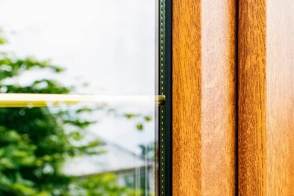 A fragment of a plastic laminated window with partitions in mirrored double-glazed Windows