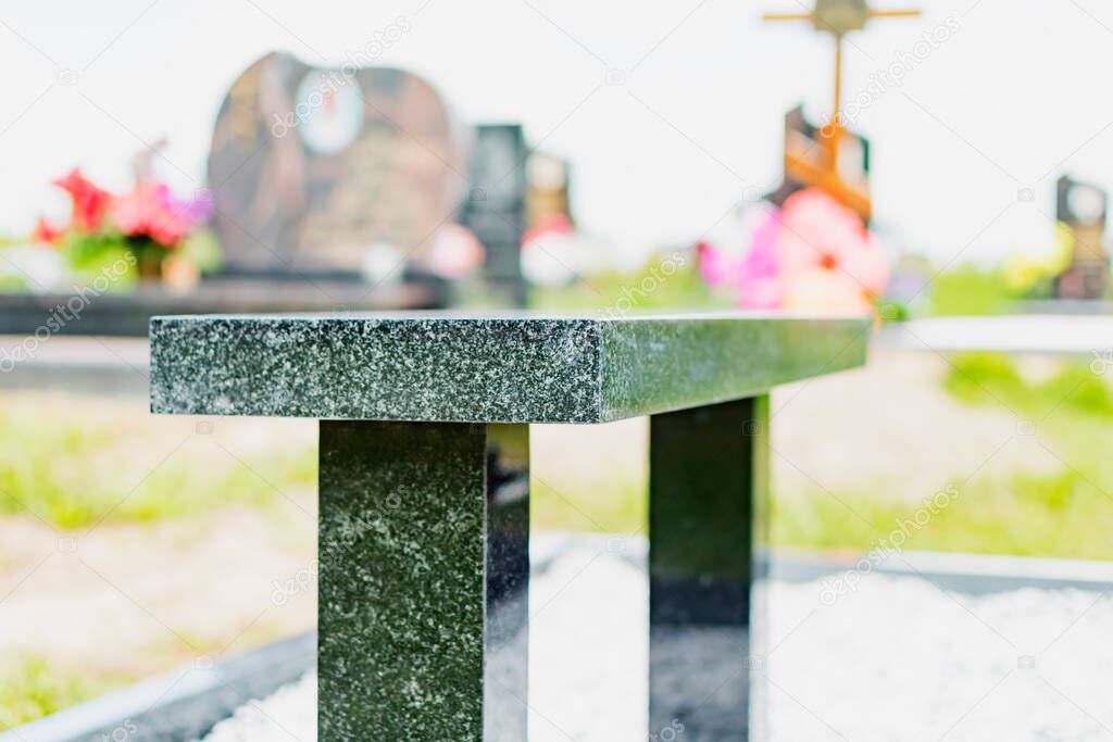 New granite bench near the headstone on the grave