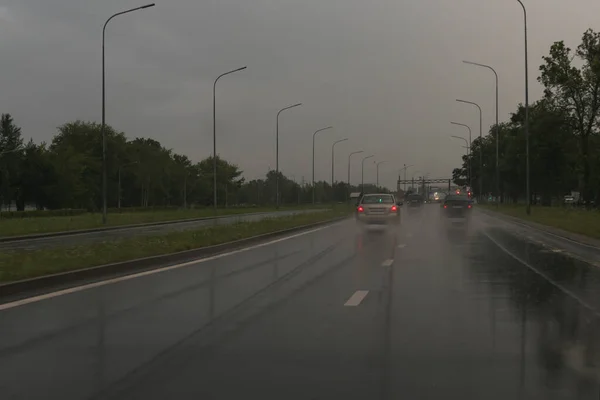 View from the car on the road in rainy weather in the evening