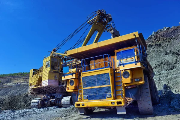Large quarry dump truck. Loading the rock in the dumper. Loading coal into body work truck. Mining truck mining machinery, to transport coal from open-pit