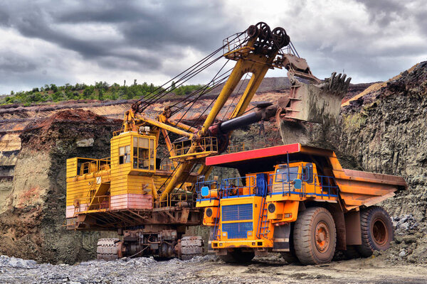 Large quarry dump truck. Loading the rock in the dumper. Loading coal into body work truck. Mining truck mining machinery, to transport coal from open-pit