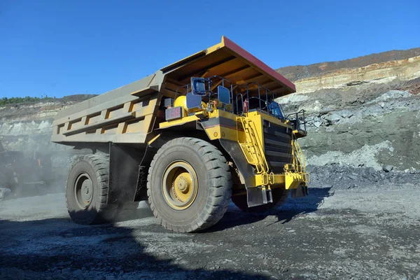 Large quarry dump truck. Loading the rock in the dumper. Loading coal into body work truck. Mining truck mining machinery, to transport coal from open-pit
