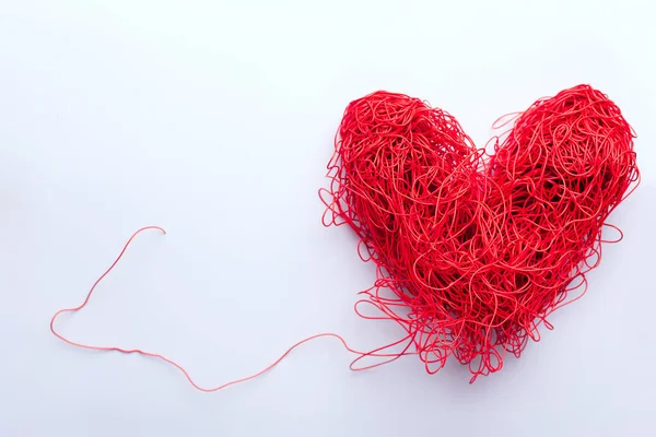 heart of red tangled wires on a white background. concept valentines day. view from above. space for text.