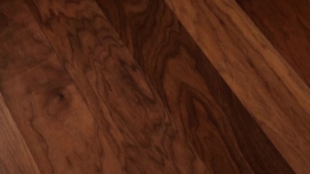 The camera moves along the floor, covered with laminated parquet with a brown wooden texture. — Stock Footage The camera moves along the floor, covered with laminated parquet with a brown wooden texture. Stock Footage
