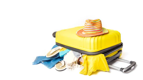 Hut auf einem gelben Koffer mit Dingen des Reisenden auf weißem Hintergrund. Konzept Schnellreisegebühren — Stockfoto