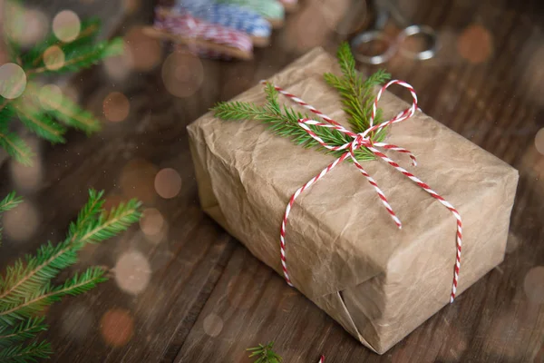 Kerstcadeaus doos presenteert op bruine houten achtergrond. kerstmis verpakt in ambachtelijk papier — Stockfoto