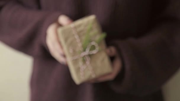 Regalos de tiempo. caja de regalo de Navidad en las niñas de la mano que usan en sweter púrpura oscuro — Vídeos de Stock