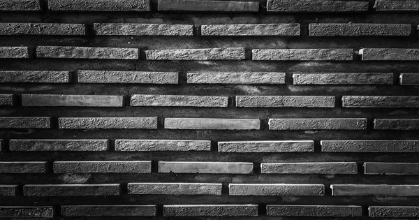 black brick wall, dark background for design. Part of black painted brick wall. Empty