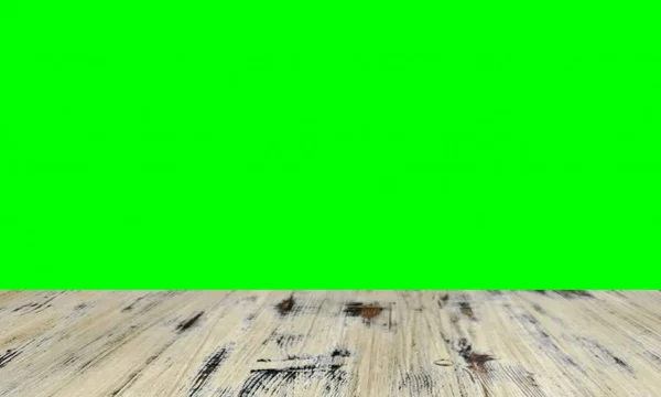 old painted washed oak wood table on the blurry chroma key green screen wall background, wooden table.
