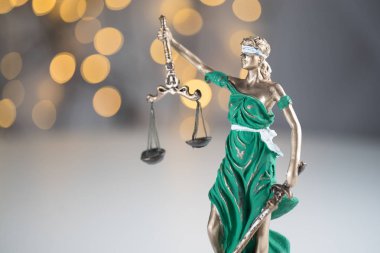 Lady Justice on golden bokeh background clipart