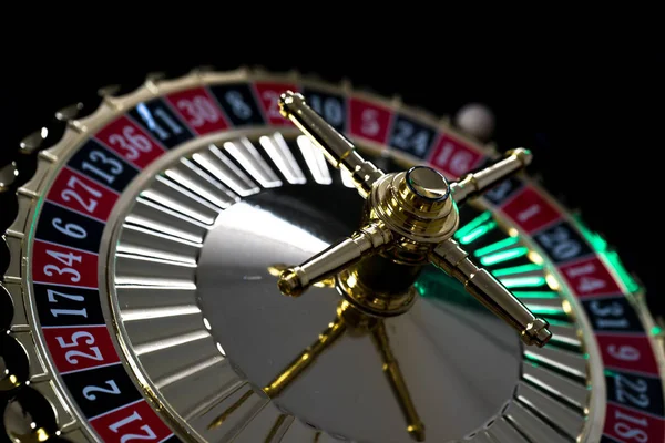 Casino background, poker Chips on gaming table, roulette wheel in motion,