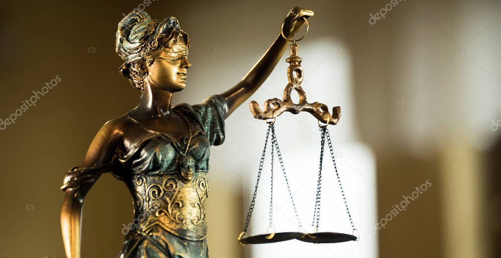 sculpture of blind Themis holding empty balance scales, mythological Greek goddess, symbol of justice