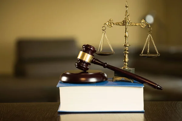 Lawyers office room with the scales of justice, book and wooden gavel