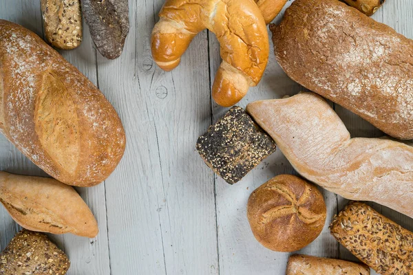 Různé Chutné Bochníky Chleba Dřevěný Stůl — Stock fotografie