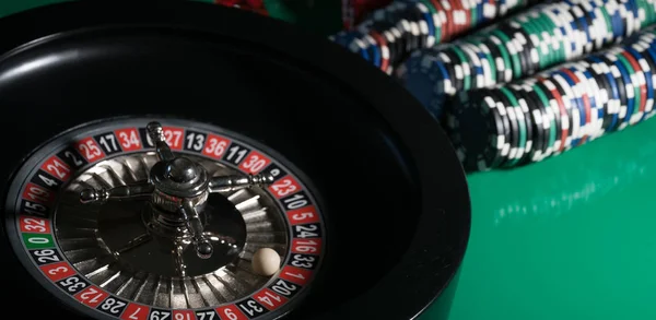 casino background, poker chips on gaming table, roulette wheel in motion