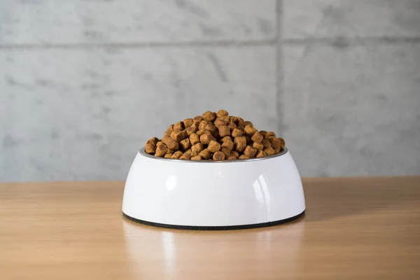 pile of dry dog food in bowl on floor