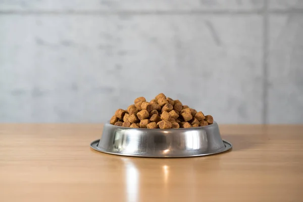 pile of dry dog food in bowl on floor