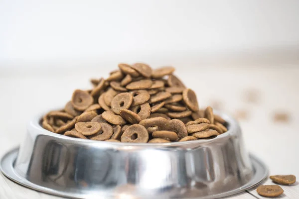 pile of dry dog food in bowl on floor