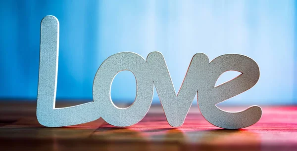 Decorative word love on blue background