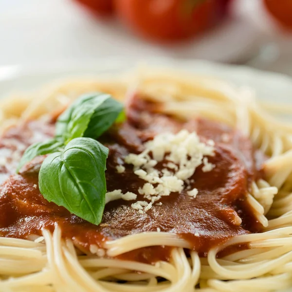 Italian pasta with tomato sauce and basil leaves