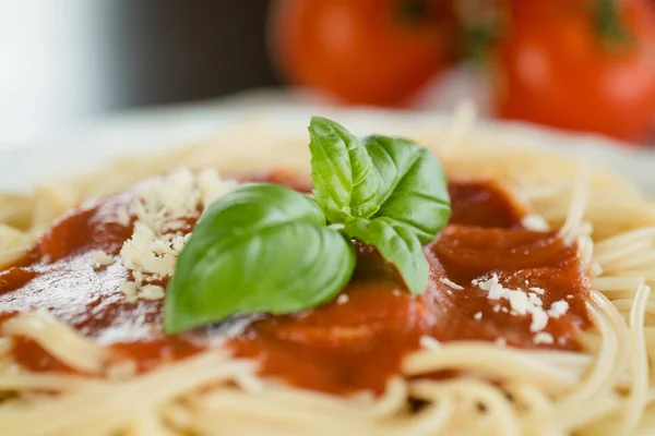 Italian pasta with tomato sauce and basil leaves