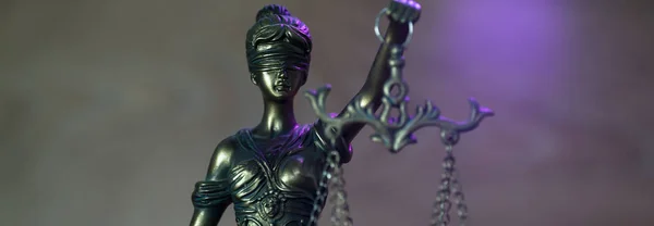 Statue of blind goddess Themis on blurred background