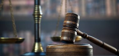 Huge judge's wooden gavel on blurred background clipart