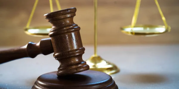 Huge judge\'s wooden gavel on blurred background