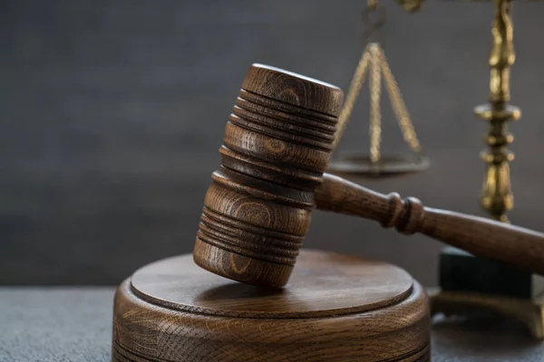 Huge judge\'s wooden gavel on blurred background