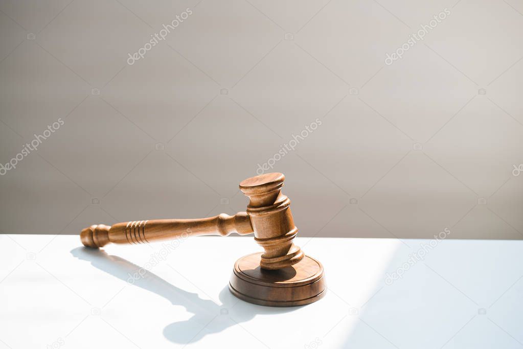 Huge judge's wooden gavel on blurred background