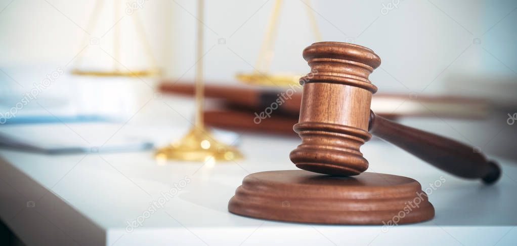 Law and Justice, judge gavel with scales on blurred background.