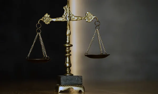 Law and Justice, scales on wooden table.