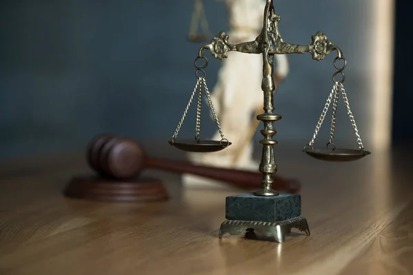 Law and Justice, judge gavel with scales on wooden table.