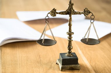 Hukuk ve Adalet, ahşap masanın üzerinde bulanık arka planı olan teraziler.