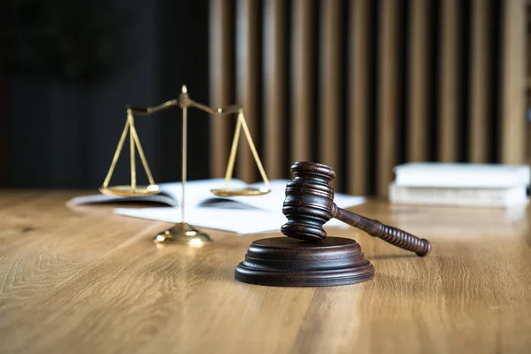 Law and Justice, judge gavel on wooden table with blurred background.