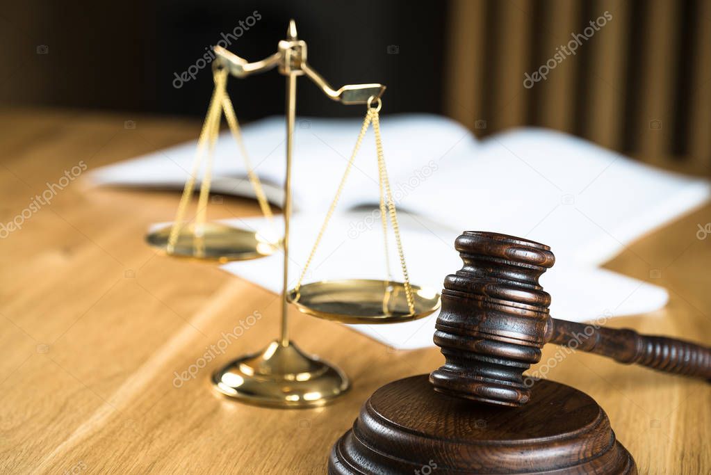 Law and Justice, judge gavel on wooden table with blurred background.