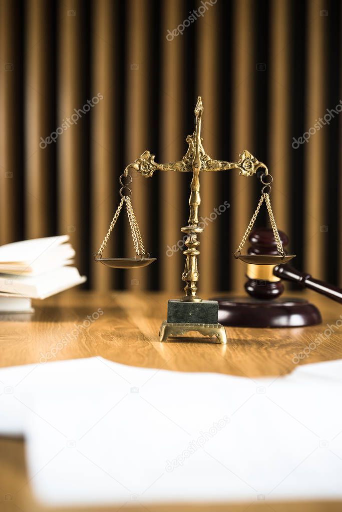 Law and Justice, judge gavel with scales on wooden table with blurred background.
