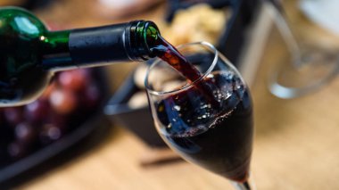 Arka planda aperatifler olan kırmızı şaraba yakın çekim