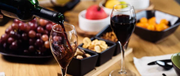 Woman pouring red wine in restaurant