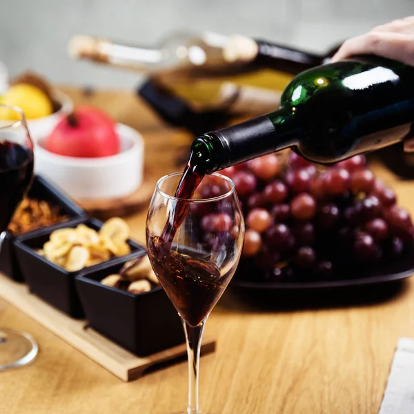 Woman pouring red wine in restaurant